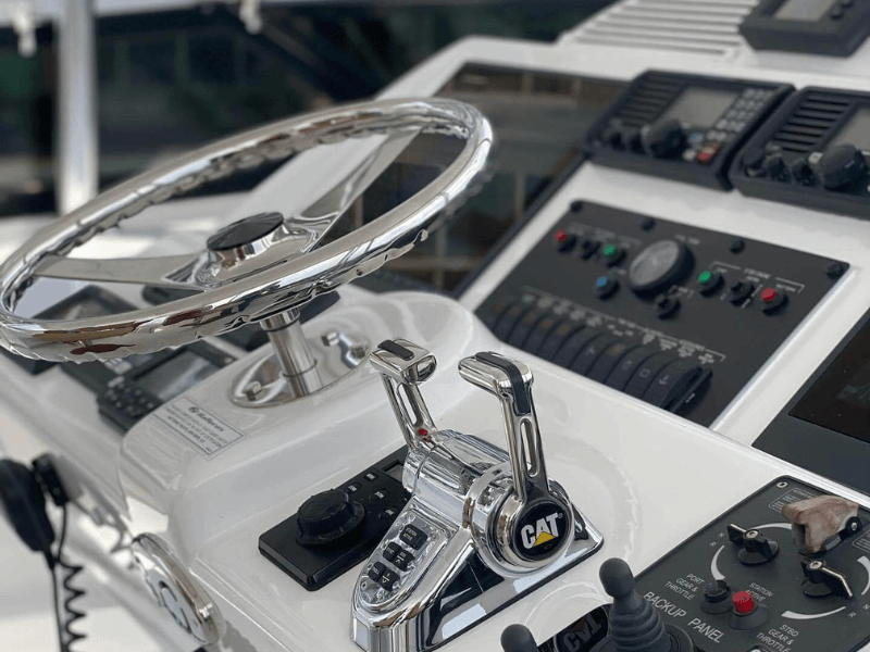 Steering wheel and controls on a boat.