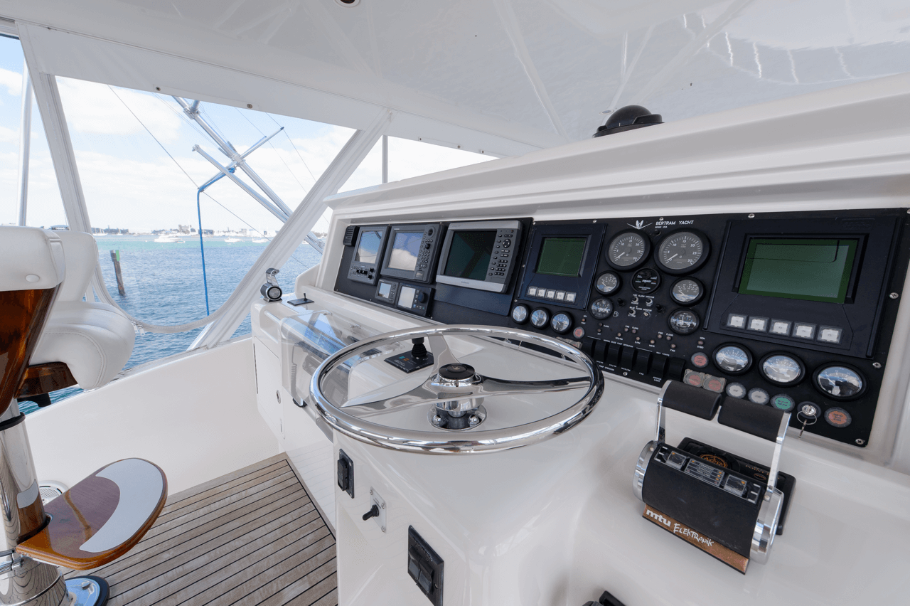 Steering wheel and controls of a large yacht.